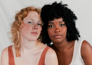 retrato-de-um-multietnico-amigo-feminino-contra-cinzento-fundo
